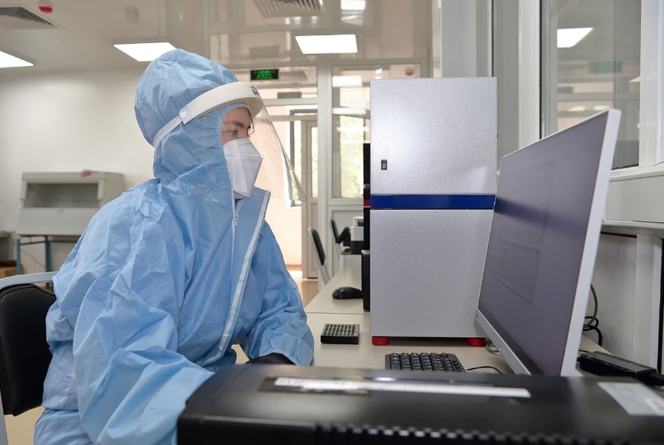 Photo of a laboratory technician reviewing PCR test results.