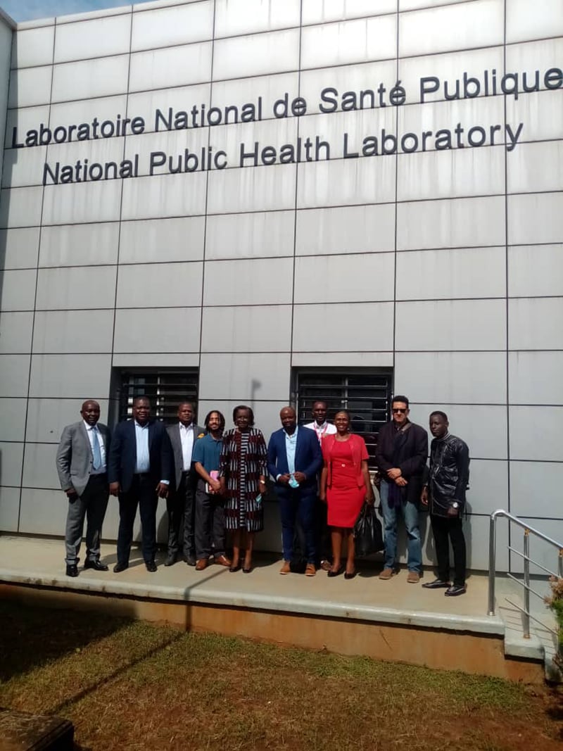 Photo of 10 U.S. CDC and CDC-Cameroon public health professionals standing in front of the National Public Health Laboratory