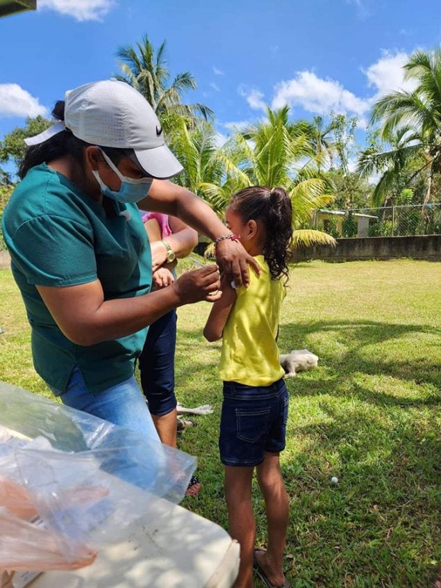 In 2022, a young girl receives the COVID-19 vaccine during a U.S. CDC-supported vaccination campaign in Honduras. Photo by MOH/ Secretaría de Salud de Honduras