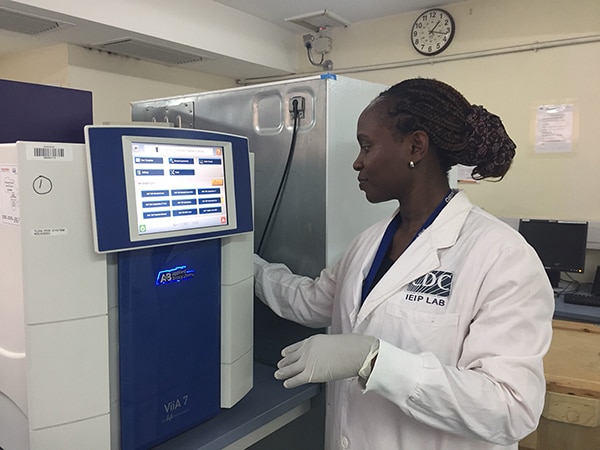 Researcher setting up a Taqman Array Card (TAC) to test for acute febrile illness on Somalia outbreak samples.