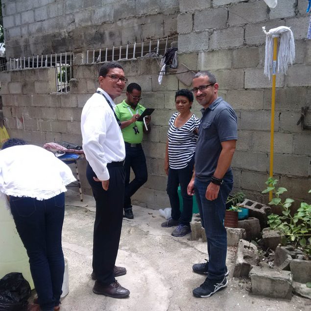 From the Dominican Republic pilot. The vector surveillance team (national level in white) performing a mosquito breeding site assessment in a home (homeowner in stripes) while the local surveillance technician (in green, holding the tablet) enters demographic information and results into the app. A member of CDC’s Epi Info team (J. Aponte, in gray) was also on hand to address any technical challenges during the pilot.