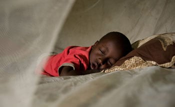 For children under five in particular, like 3-year-old Fadhil Smith, 3, bed nets provided by the CDC can literally mean the difference between life and death. CDC figures show that where once children were exposed to as many as 300 infected mosquito bites each year, the number today is closer to three.<br>© David Snyder/CDC Foundation