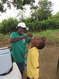 Boy receiving the oral cholera vaccine at a vaccination post.