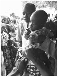 A child receives vaccine as part of a mass vaccination campaign in Sub-Saharan Africa