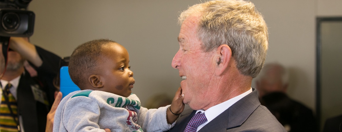 President Bush holds a baby