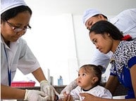 healthcare workers examine child