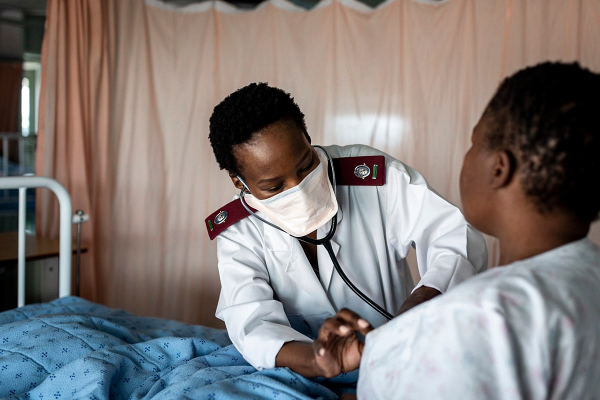 healthcare worker examines patient