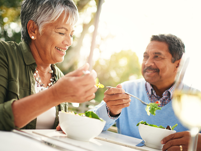 Woman and man eating salad