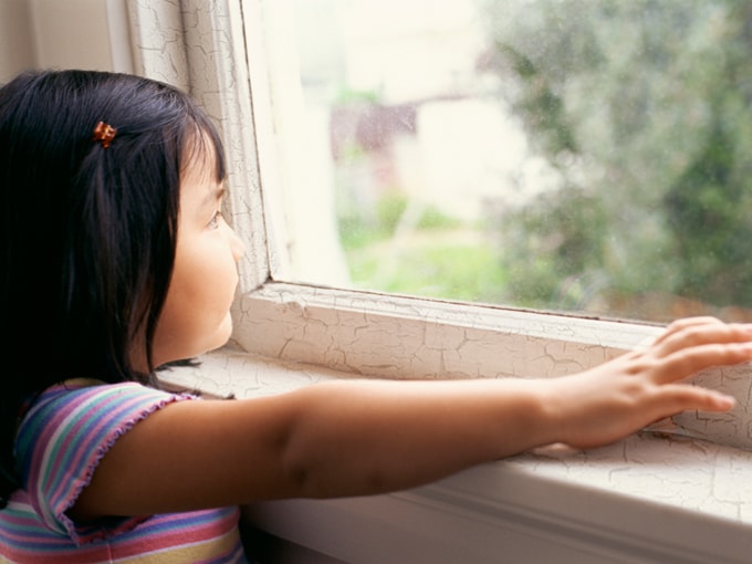 Young girl looking out the window
