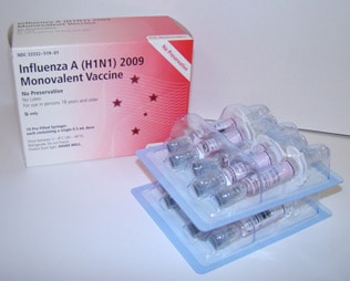 Picture of box of 10 pre-filled syringes of Influenza A (H1N1) 2009 Monovalent Vaccine with no preservatives with syringe packages in front