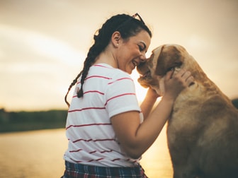 thumbnail image of a woman with her dog outdoors