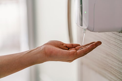 Woman using hand sanitizer gel