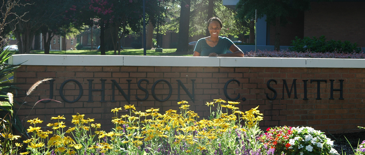 Kameron Sheats standing behind the Johnson C. Smith University wall sign