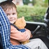 Boy in a car seat with a teddy bear