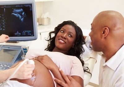 Pregnant African American woman undergoing an ultrasound exam