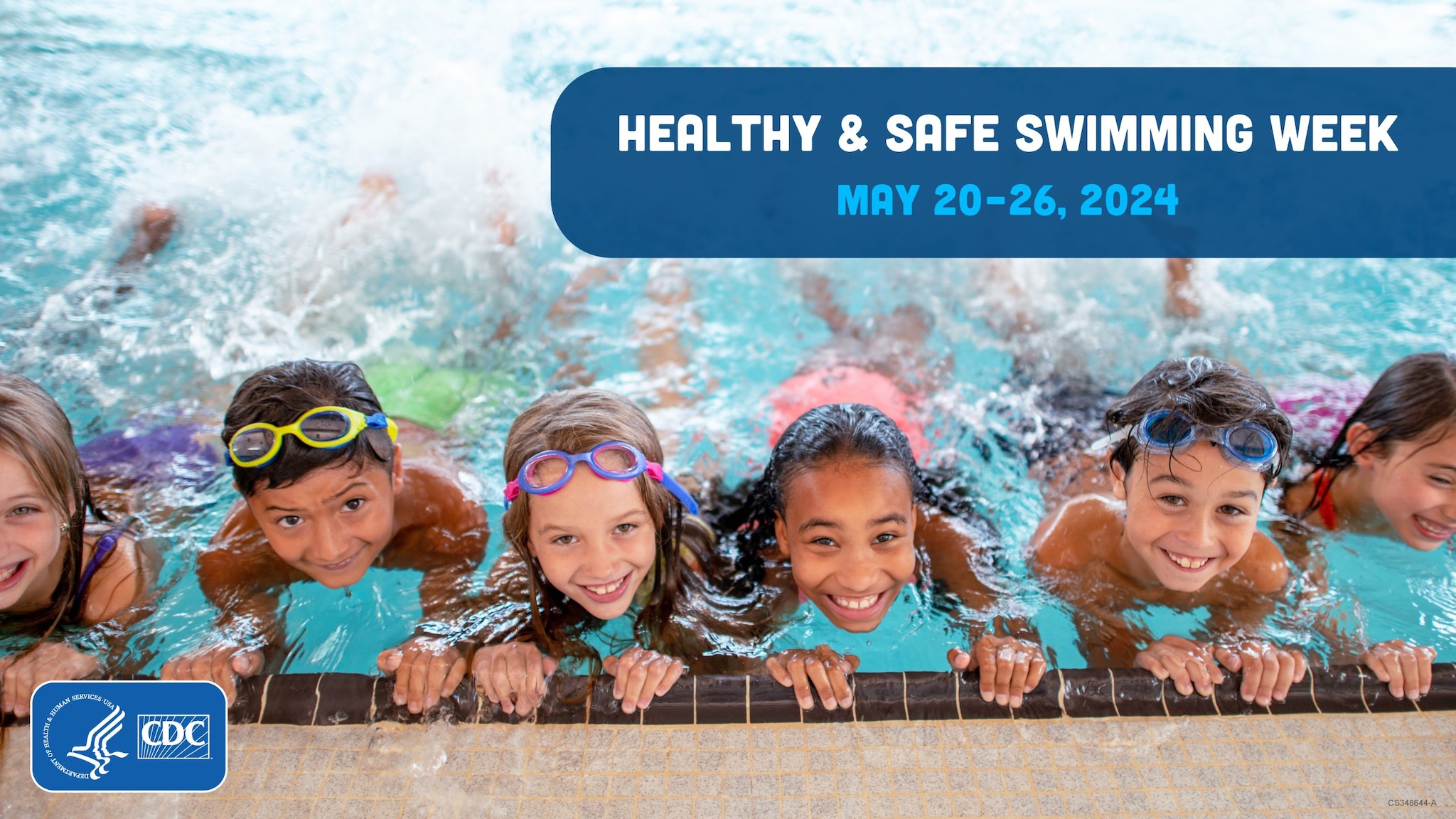 Children in a pool holding on to the edge and kicking their legs behind them while all in a row smiling.