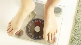 Person's feet on home scales.