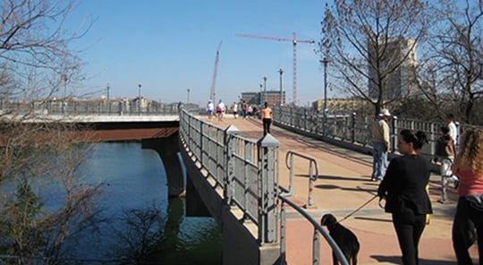 people walking across a bridge