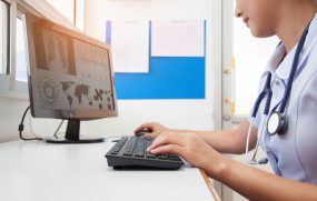 Doctor working with computer at desk in the hospital
