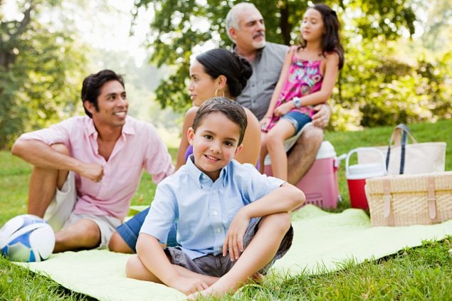 Multi-generational, American Indian family enjoying a picnic.
