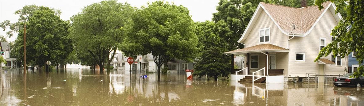 house surrounded by flood waters