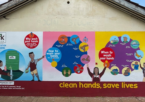 Mural on school building illustrating  handwashing steps and encouraging students to practice hand hygiene. Nairobi, Kenya.