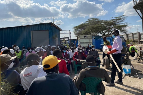 Public health partners in Kenya train sanitation workers who empty pit latrines on hygiene practice and personal protective equipment use.