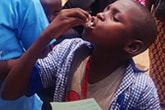 A young boy takes a dose of the oral cholera vaccine distributed in his village in northern Cameroon.