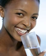 Photo of a woman drinking water from a glass