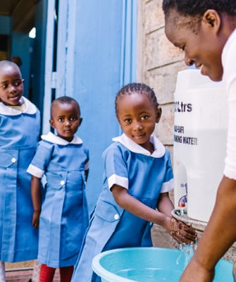 Image of young girls having access to  outdoor handwashing facilities