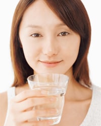 A woman with a glass of water.