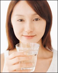 Photo: A woman with a glass of water.