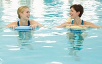 Two women in a swimming pool.