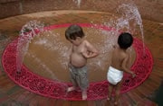 toddlers playing in interactive fountain