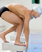 man starting a race in a swimming pool