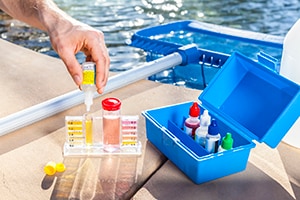 man testing chlorine levels with a testing kit