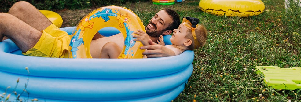 Father and son in a kiddie pool