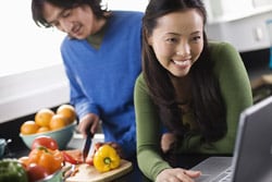 A couple looking at recipes online while cooking