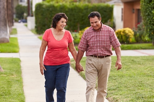 Couple Walking Along Sidewalk Together
