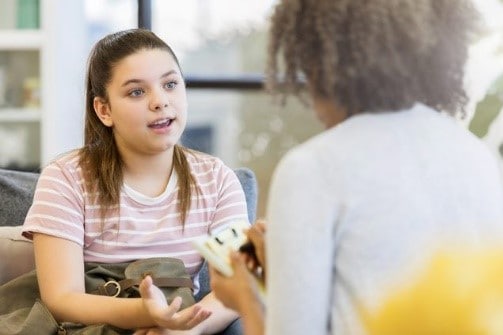 A female student talking with a school counselor