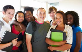 diverse group of teens in school hallway