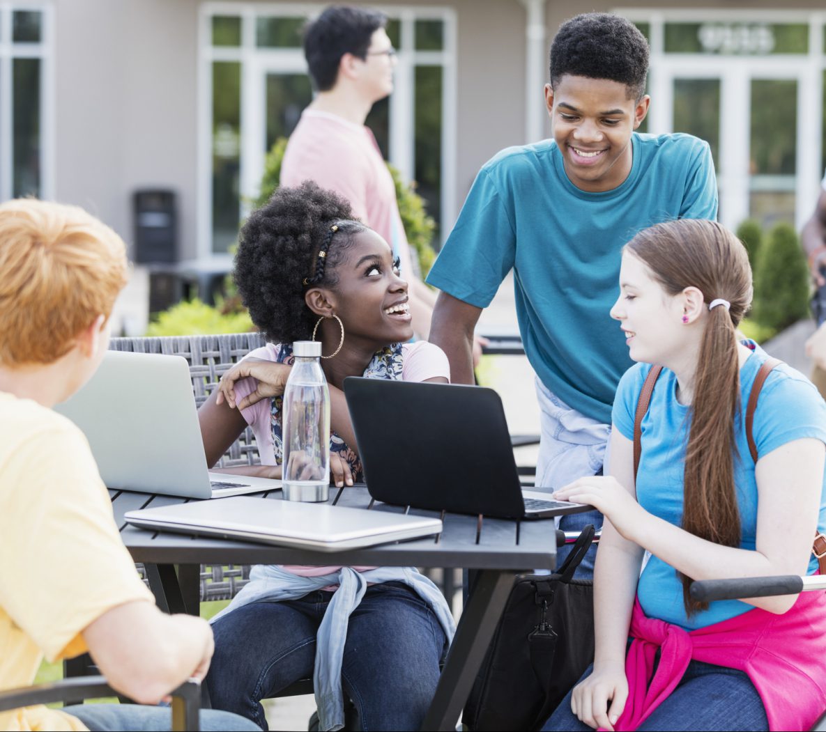 Group of diverse students studying outdoors