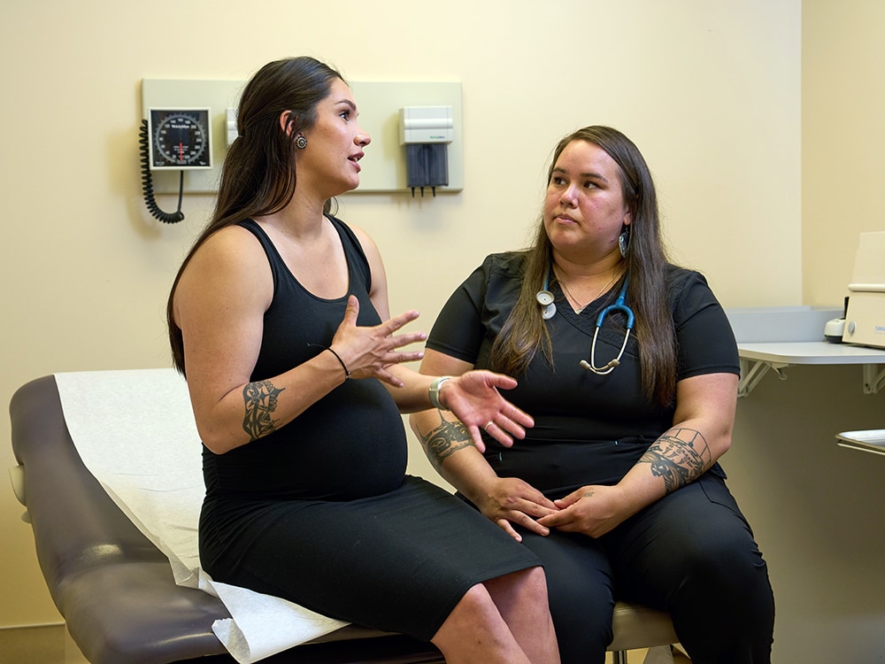 Pregnant woman talking with healthcare professional