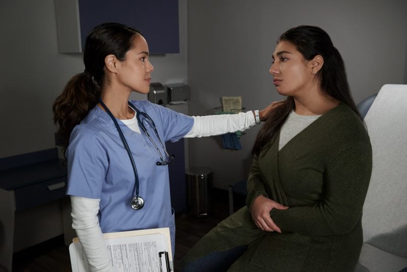 A provider talking to a female patient