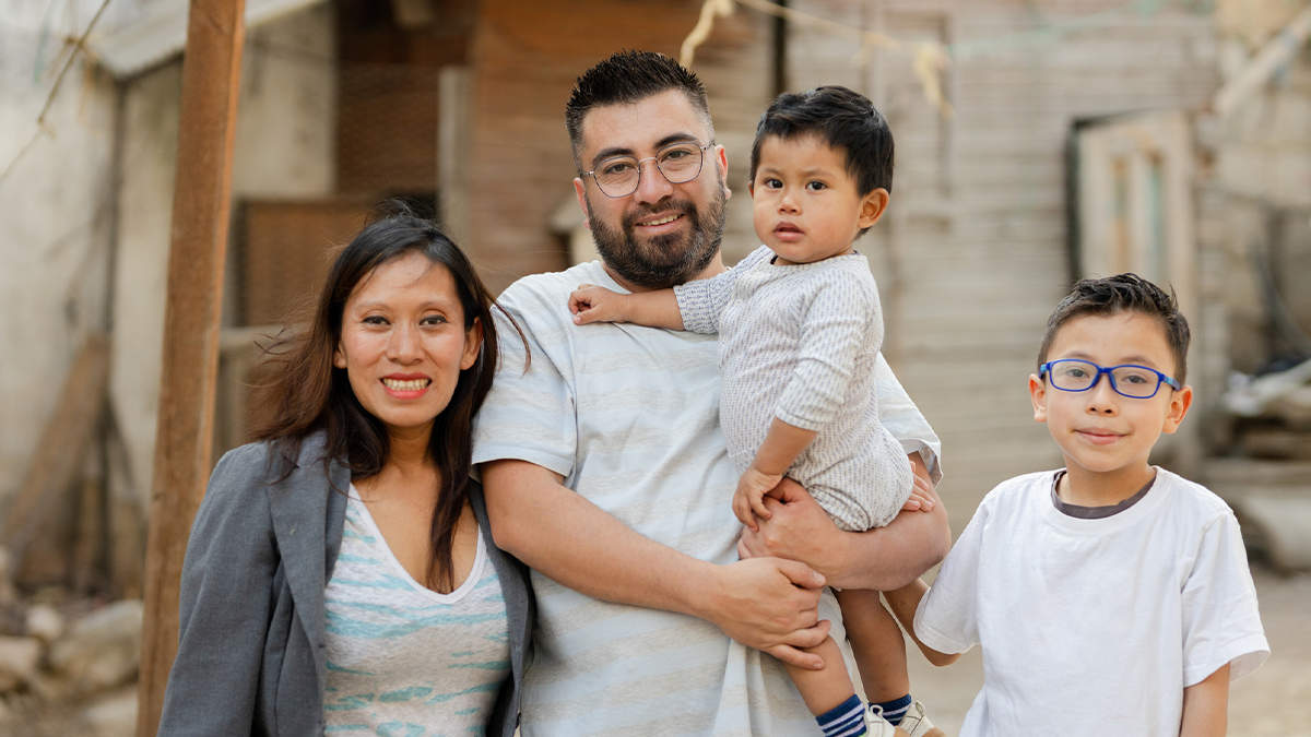 family of four smiling together