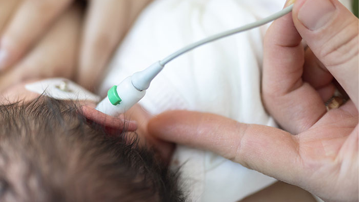 Newborn baby receiving a hearing screening test