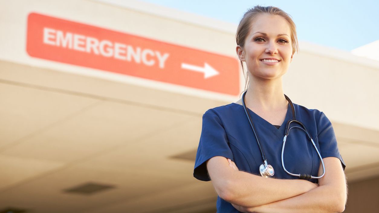 Doctor standing in front of emergency sign