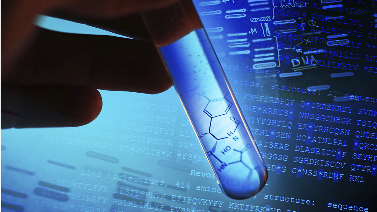 a hand holding a test tube with sequencing in the background