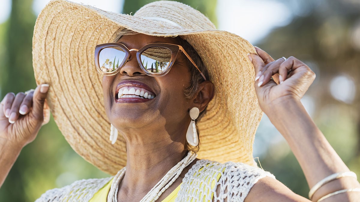 senior african american woman wearing sunglasses and hat