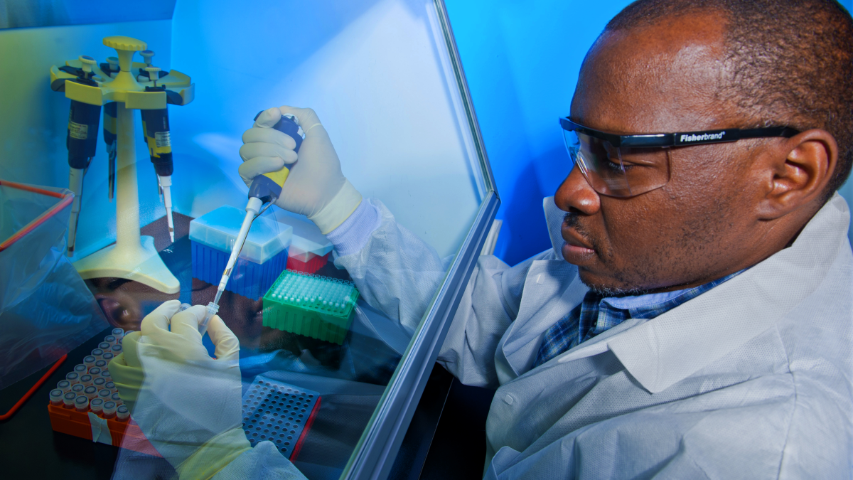 A CDC laboratorian preps for testing using polymerase chain reaction.